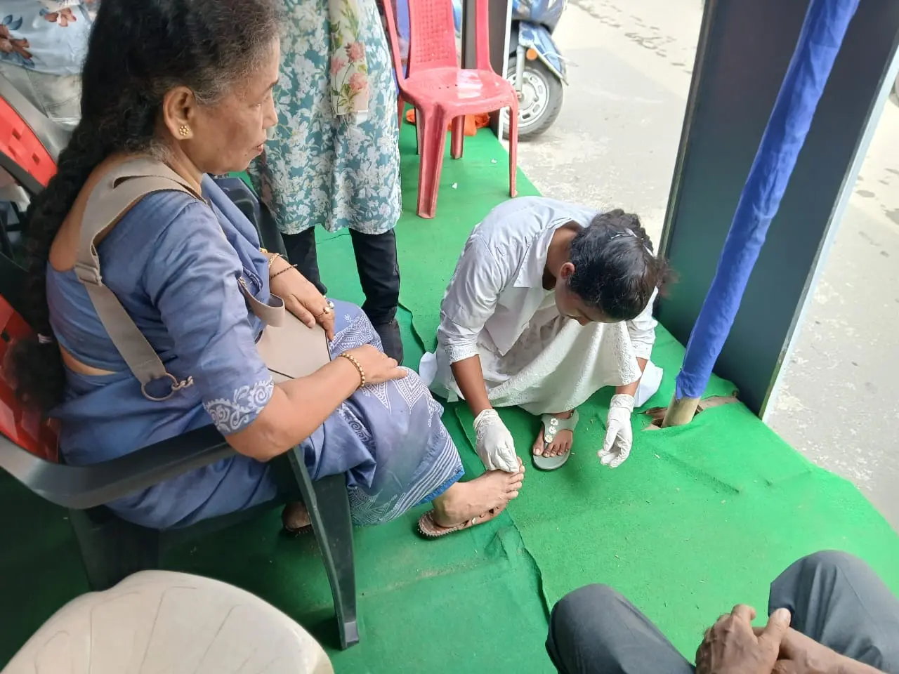 A visitor being attended to beside the pandal